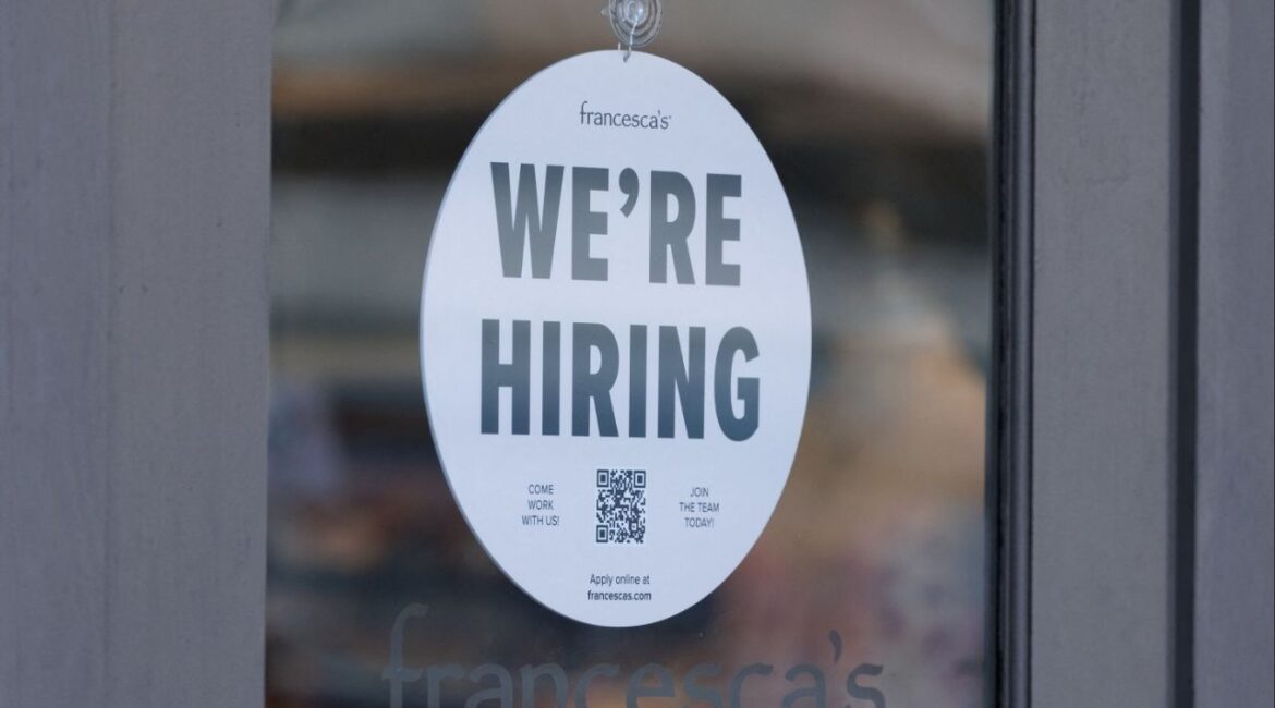 A "we're hiring" sign is displayed on the door of a local business, after U.S. employment growth slowed more than expected in July, in Encinitas, California, U.S. August 1, 2025. (Reuters File)