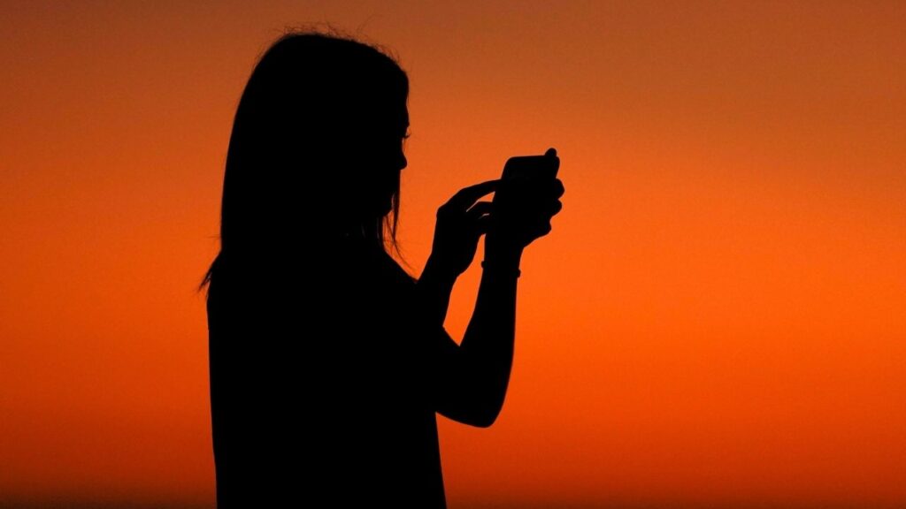 A young girl uses her phone to record the sky after sun set in Encinitas, California, U.S. October 7, 2019. (Reuters File)