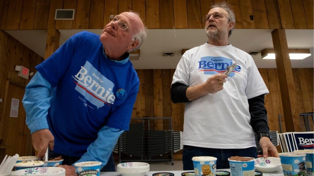 Ben Cohen, left, and Jerry Greenfield, right, of Ben and Jerry's Ice Cream brand, dish out ice cream at an event for Democratic presidential hopeful Bernie Sanders in Ottumwa, Iowa Jan., 28, 2020. One of Ben & Jerry’s founders, Jerry Greenfield, has resigned from the ice cream company, saying that its independence had been lost and its social activism “silenced” under the control of its parent company, Unilever. (Ruth Fremson/The New York Times)