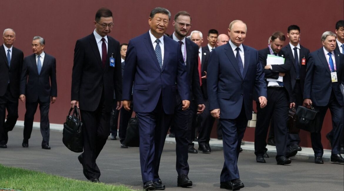 Chinese President Xi Jinping and Russian President Vladimir Putin walk at the personal residence of the Chinese leader Zhongnanhai in Beijing, China September 2, 2025. Sputnik/Alexander Kazakov/Pool via REUTERS
