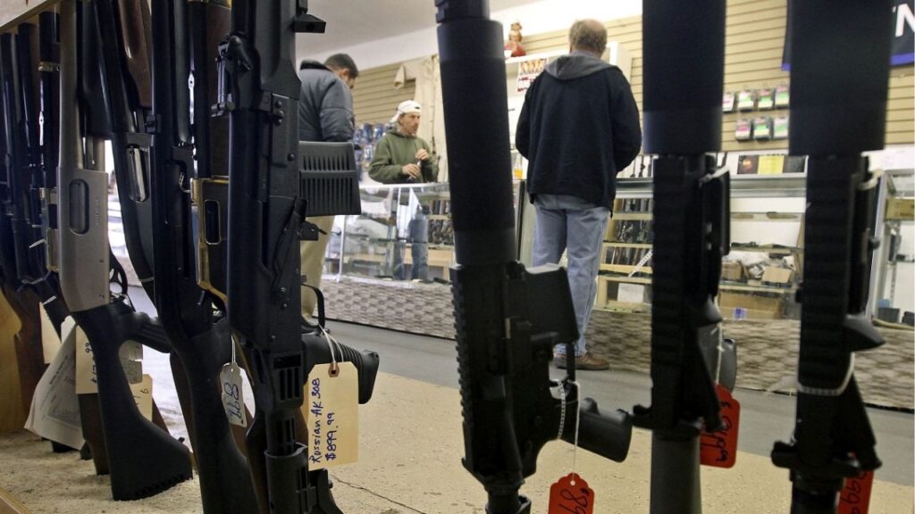 Customers are seen shopping for handguns through a rack of assault rifles at the Guns-R-Us gun shop in Phoenix, Arizona, December 20, 2012. (Reuters File)