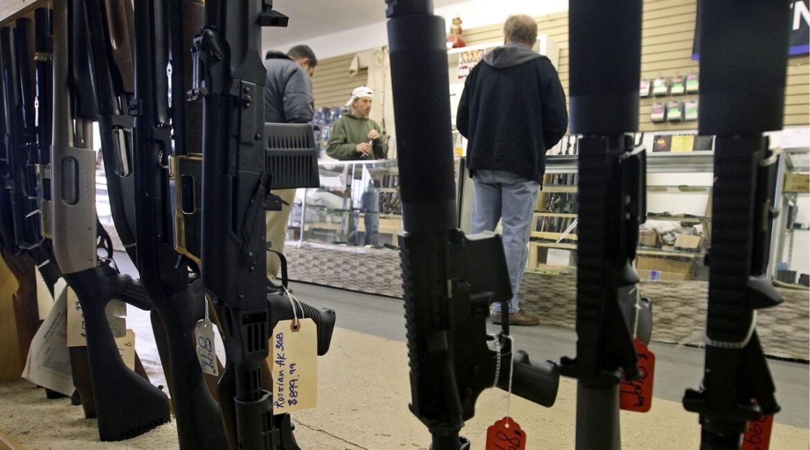 Customers are seen shopping for handguns through a rack of assault rifles at the Guns-R-Us gun shop in Phoenix, Arizona, December 20, 2012. (Reuters File)