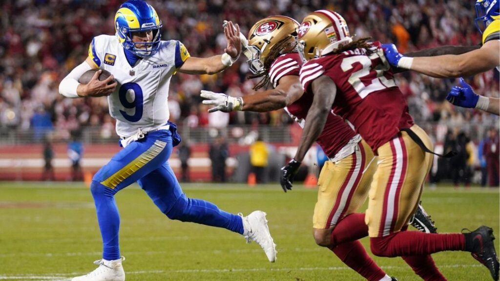 Dec 12, 2024; Santa Clara, California, USA; Los Angeles Rams quarterback Matthew Stafford (9) runs with the ball as San Francisco 49ers linebacker Fred Warner (54) defends in the fourth quarter at Levi's Stadium. (Cary Edmondson-Imagn Images)