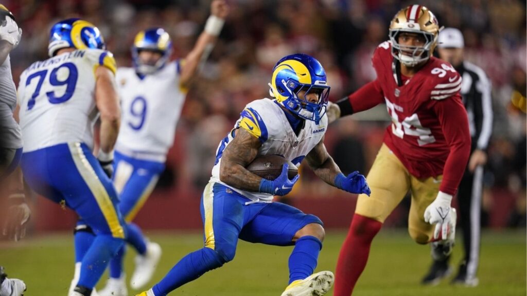 Dec 12, 2024; Santa Clara, California, USA; Los Angeles Rams running back Kyren Williams (23) runs past San Francisco 49ers defensive end Yetur Gross-Matos (94) in the fourth quarter at Levi's Stadium. (Cary Edmondson-Imagn Images)