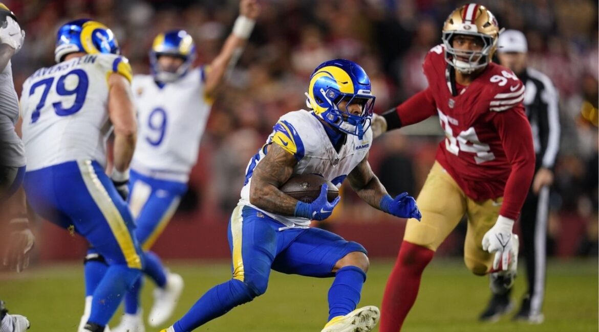 Dec 12, 2024; Santa Clara, California, USA; Los Angeles Rams running back Kyren Williams (23) runs past San Francisco 49ers defensive end Yetur Gross-Matos (94) in the fourth quarter at Levi's Stadium. (Cary Edmondson-Imagn Images)