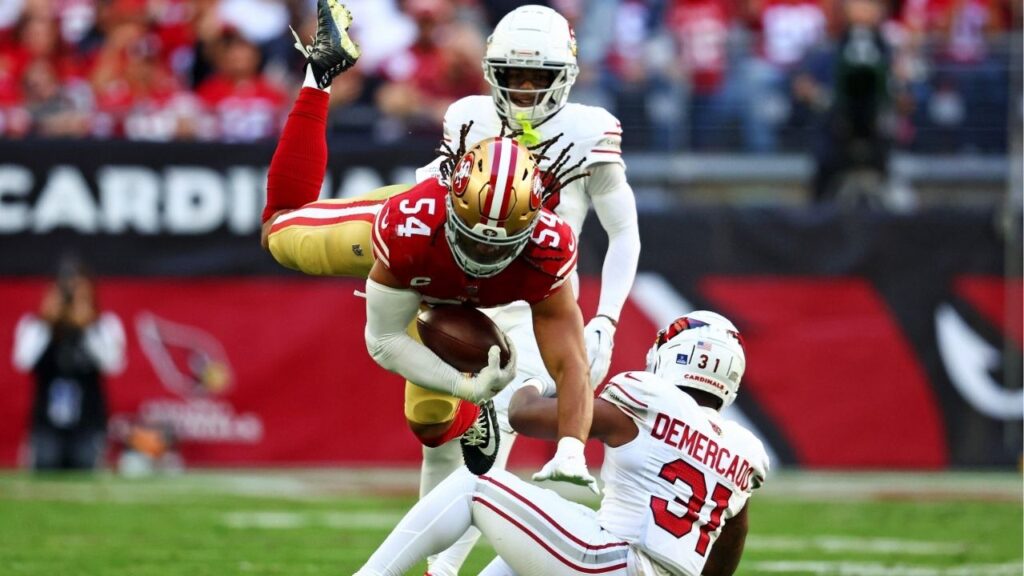 Dec 17, 2023; Glendale, Arizona, USA; San Francisco 49ers linebacker Fred Warner (54) leaps over San Francisco 49ers safety Tashaun Gipson Sr. (31) during the first quarter at State Farm Stadium. (Mark J. Rebilas-USA TODAY Sports)