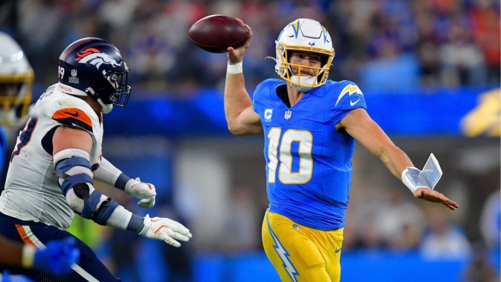Dec 19, 2024; Inglewood, California, USA; Los Angeles Chargers quarterback Justin Herbert (10) throws as Denver Broncos defensive end Zach Allen (99) moves in during the second half at SoFi Stadium. (Gary A. Vasquez-Imagn Images)