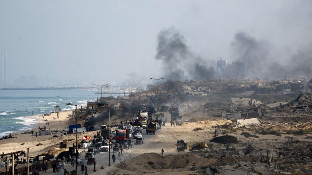 Displaced Palestinians, fleeing northern Gaza due to an Israeli military operation, move southward along a destroyed area after Israeli forces ordered residents of Gaza City to evacuate to the south, in the central Gaza Strip, September 23, 2025. (Reuters/Mahmoud Issa)