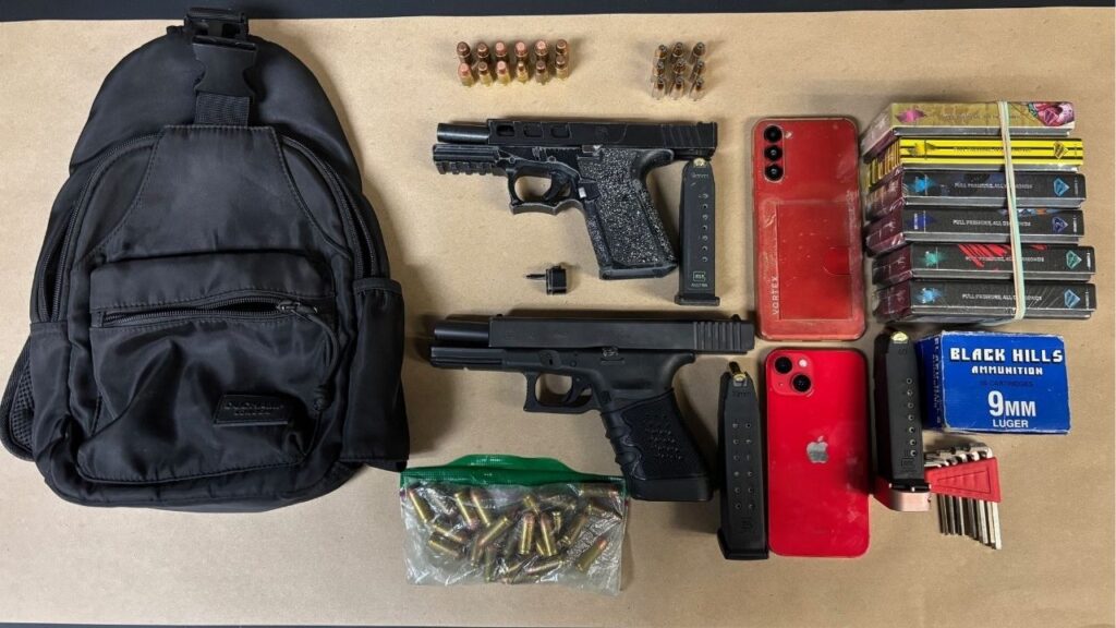Fresno police arrested a driver in the Northwest District after a traffic stop uncovered alcohol, two firearms, ammunition, and a gun part. (Fresno PD)