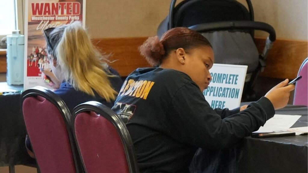 Job seekers fill out applications during a job fair. (USA Today Network Via Reuters)