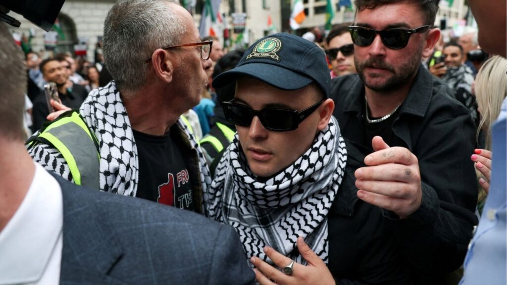 Member of Kneecap Liam O'Hanna, also known as Liam Og O hAnnaidh and performing under the name of Mo Chara, who has been charged with a terrorism offence in relation to the alleged display of a Hezbollah flag onstage in 2024, walks outside the Westminster Magistrates' Court, in London, Britain, August 20, 2025. (Reuters File)