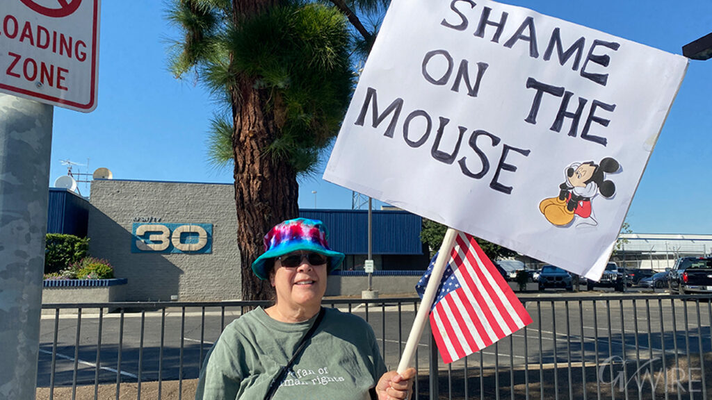 Monica Etheridge of Clovis protests in front of the ABC 30 studios over the removal of Jimmy Kimmel.