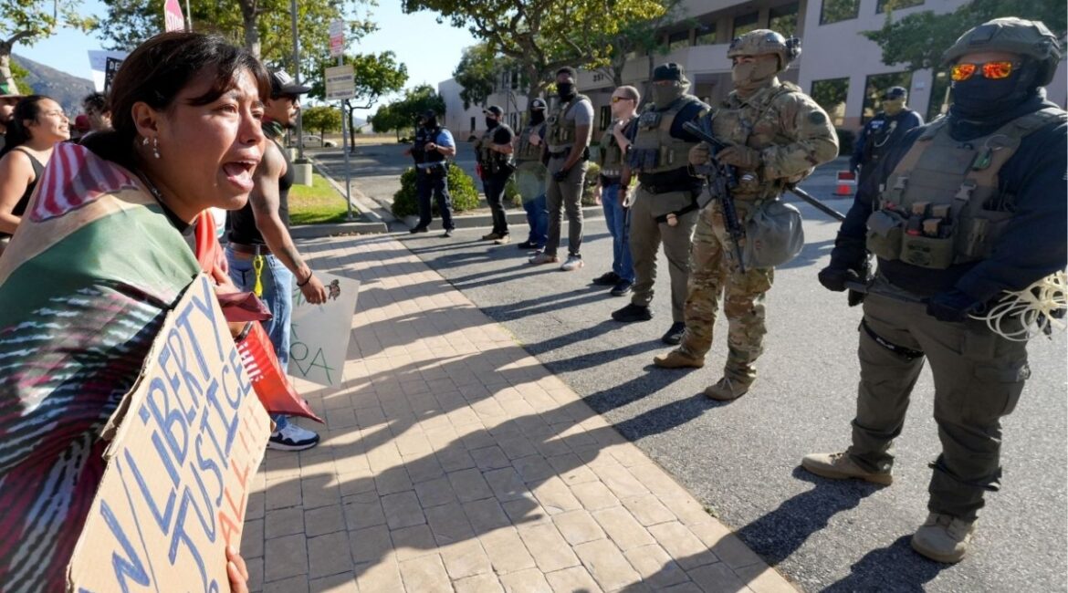 Monica Montoya of Oxnard protests and cries at the sight of armed federal immigration agents as she joins a large group outside a U.S. Immigration and Customs Enforcement field office in Camarillo on July 14, 2025. Demonstrators railed against immigration enforcement actions, including the July 10 raid at Glass House Farms near Camarillo. (Palm Springs Desert Sun via Reuters)