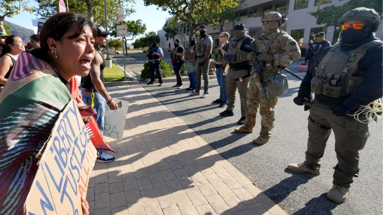 Monica Montoya of Oxnard protests and cries at the sight of armed federal immigration agents as she joins a large group outside a U.S. Immigration and Customs Enforcement field office in Camarillo on July 14, 2025. Demonstrators railed against immigration enforcement actions, including the July 10 raid at Glass House Farms near Camarillo. (Palm Springs Desert Sun via Reuters)