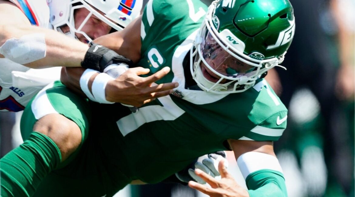New York Jets quarterback Justin Fields (7) loses control of the ball after running and being tackled by Buffalo Bills defensive end Joey Bosa (97), Sunday, September 14, 2025, in East Rutherford. (USA Today Network via Reuters)