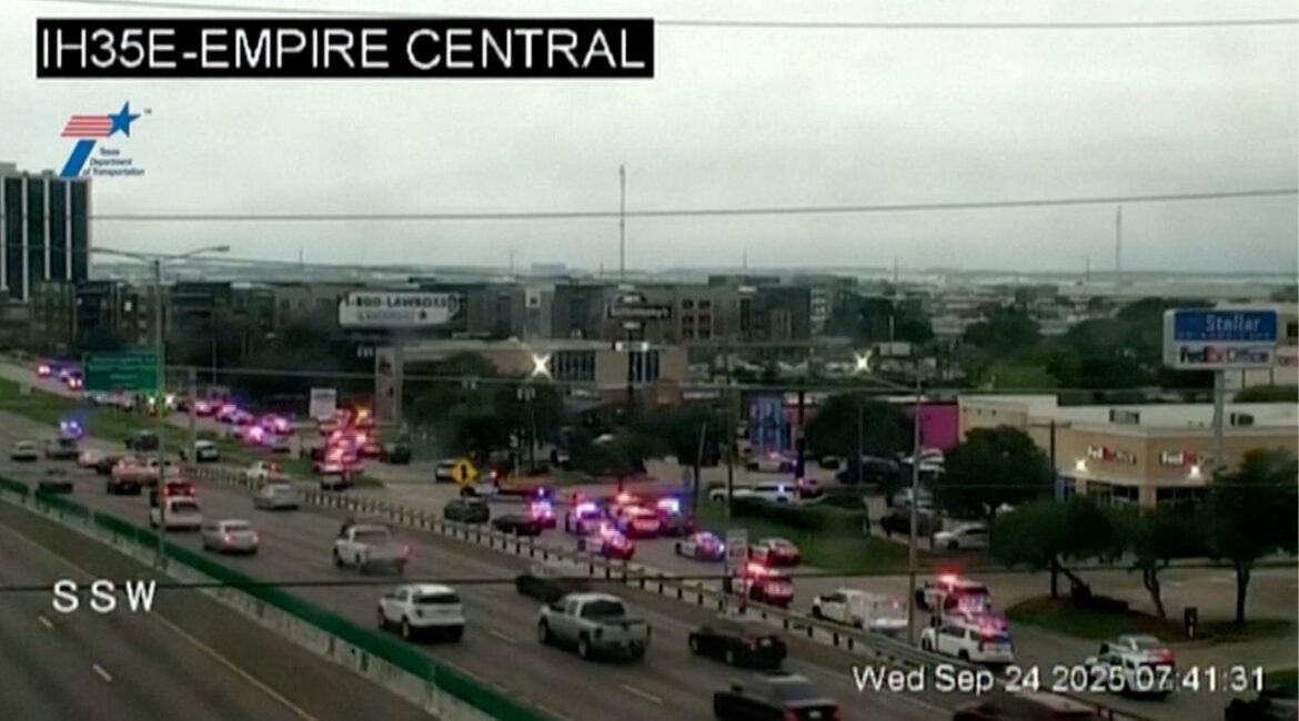 Police cars and ambulances stand outside a ICE facility where a shooting took place in Dallas, Texas, U.S. September 24, 2025 in this screengrab taken from a handout traffic camera video. Texas Department Of Transportation /via Reuters TV/Handout via REUTERS