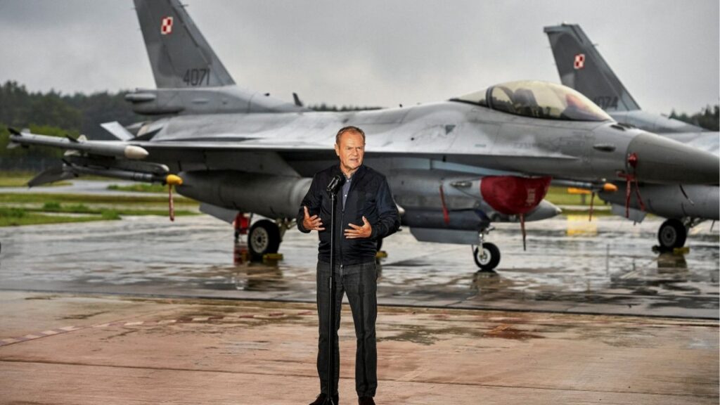 Polish Prime Minister Donald Tusk stands in front of Polish Air Force F-16 fighter jets as he holds a press conference regarding the threat posed by Russian drones in Polish airspace at the 32nd Tactical Air Base in Lask, about 30 km south-west of Lodz, Poland, September 11, 2025. Agencja Wyborcza.pl/Tomasz Stanczak via REUTERS