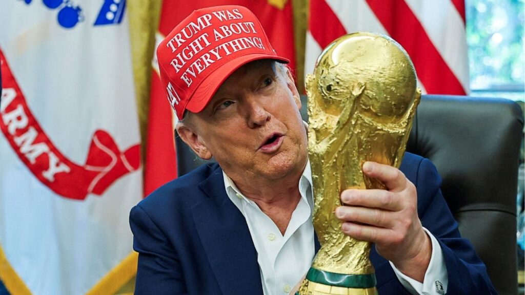 President Donald Trump wears a 'Trump Was Right About Everything!' hat while holding the FIFA World Cup Trophy, as he makes an announcement on the 2026 FIFA World Cup, in the Oval Office at the White House in Washington, D.C., U.S., August 22, 2025. (Reuters File)
