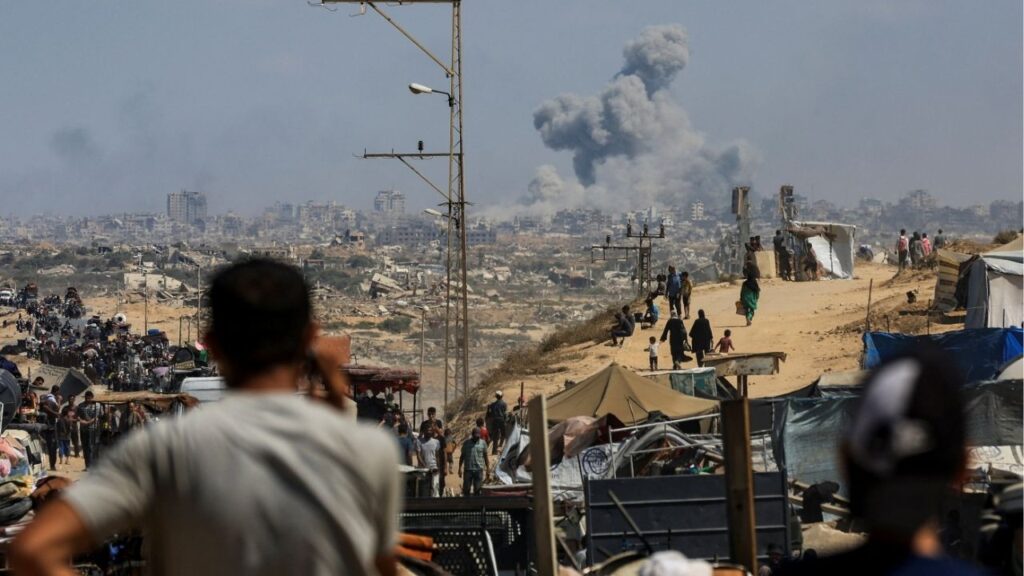 Smoke rises from an Israeli strike, as displaced Palestinians, fleeing northern Gaza due to an Israeli military operation, move southward after Israeli forces ordered residents of Gaza City to evacuate to the south, in the central Gaza Strip September 24, 2025. (Reuters/Dawoud Abu Alkas)