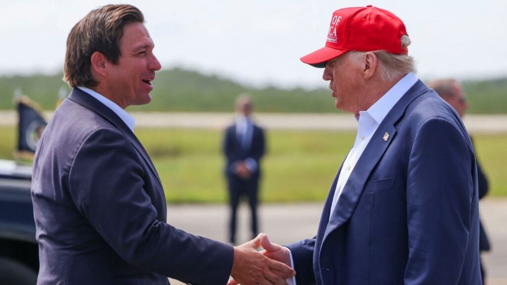 U.S. President Donald Trump shakes hands with Florida Governor Ron DeSantis at the Dade-Collier Training and Transition Airport on the day of the opening of a temporary migrant detention center informally known as "Alligator Alcatraz" in Ochopee, Florida, U.S., July 1, 2025. (Reuters/Evelyn Hockstein)