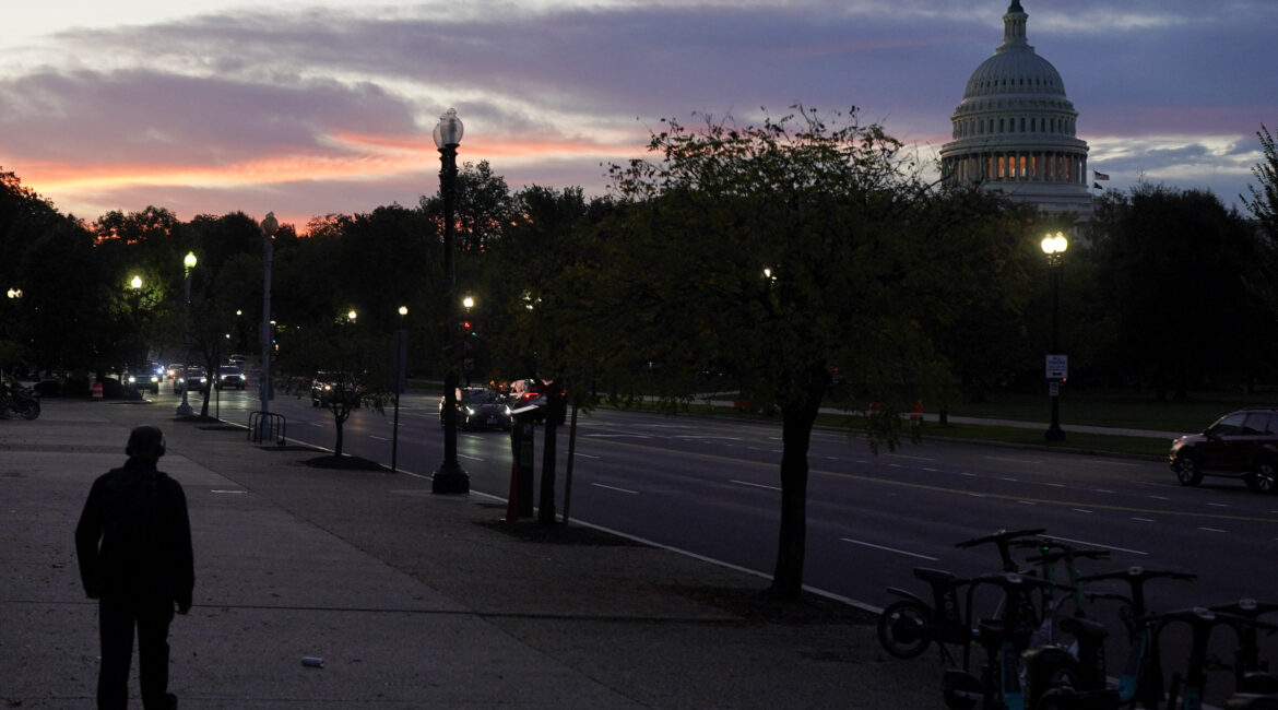 A person walks, with the U.S. Capitol dome in the background, during the first day of a partial government shutdown in Washington, D.C., U.S., October 1, 2025. (Reuters/Nathan Howard)