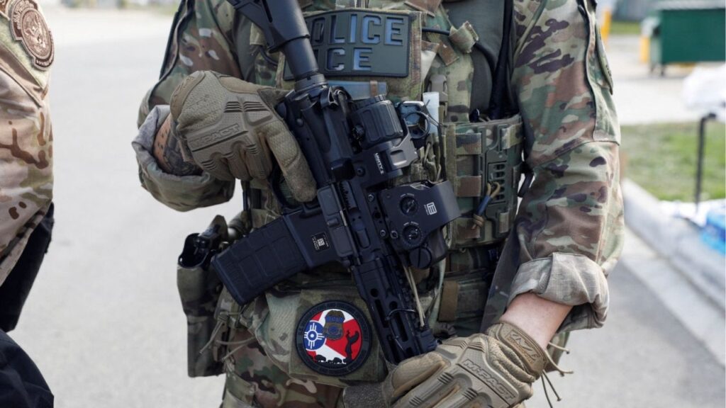 A U.S. Immigration and Customs Enforcement officer holds a weapon during a protest outside an ICE facility in Broadview, Illinois, U.S., September 12, 2025. (Reuters File)