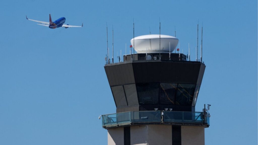 A commercial airliner takes off past the air traffic control tower at San Diego International Airport during the first day of a partial U.S. government shutdown in San Diego, California, U.S., October 1, 2025. (Reuters/Mike Blake)