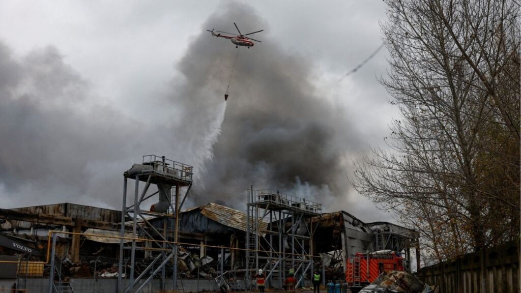 A firefighting helicopter drops water over food warehouses hit by an overnight Russian missile strike, amid Russia’s attack on Ukraine, in Kyiv, Ukraine October 25, 2025. (Reuters/Valentyn Ogirenko)