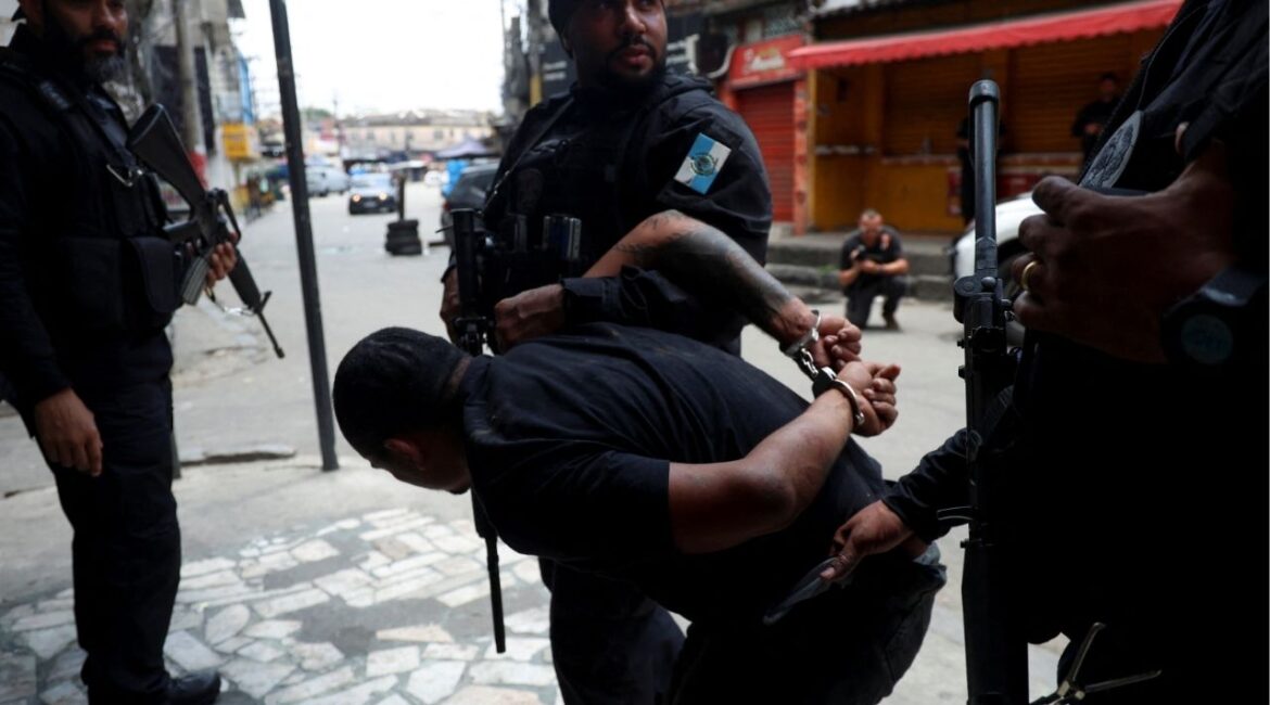 A man is detained by police officers during a police operation against drug trafficking at the favela do Penha, in Rio de Janeiro, Brazil October 28, 2025. (Reuters/Aline Massuca)