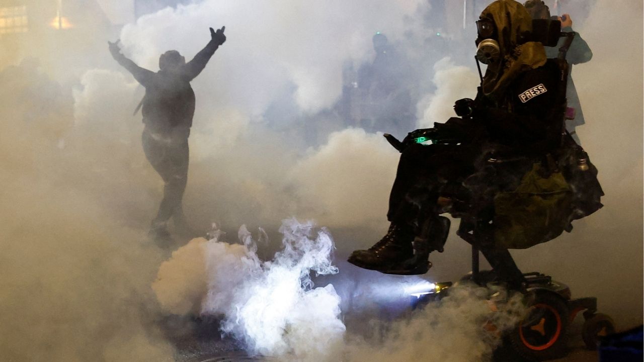 A person gestures amid tear gas as law enforcement officers advance to disperse demonstrators near U.S. Immigration and Customs Enforcement (ICE) headquarters in Portland, Oregon, U.S., October 4, 2025. (Reuters/John Rudoff)
