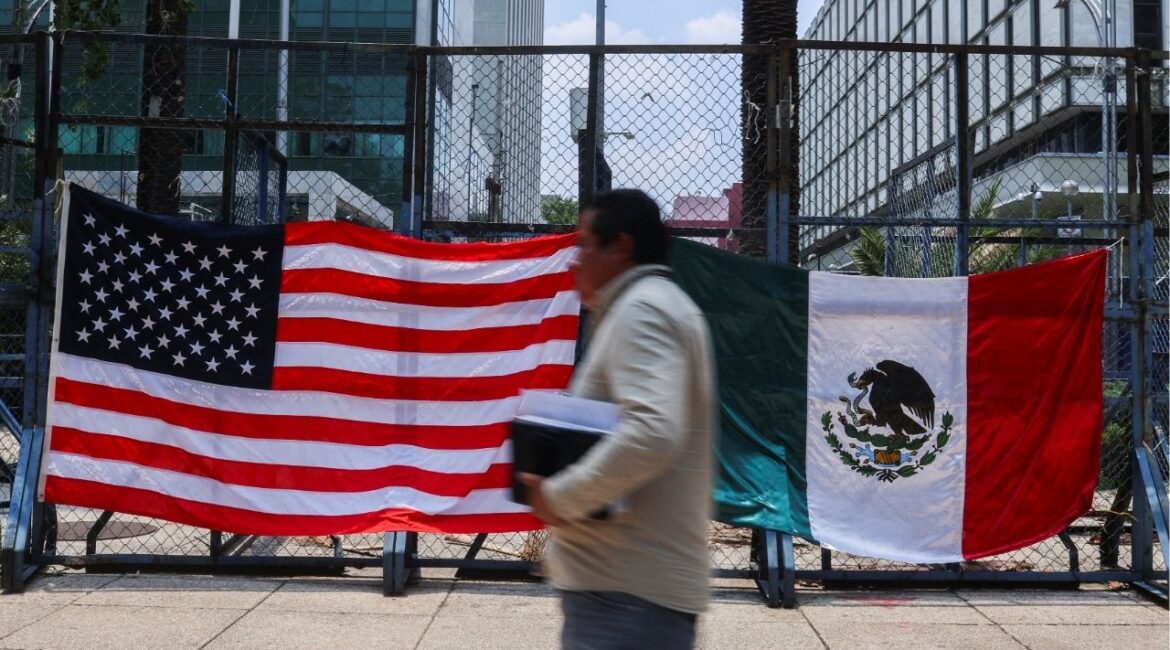 A person passes by Mexican and U.S flags placed outside the U.S. Embassy in Mexico City, Mexico June 9, 2025. (Reuters/Raquel Cunha)