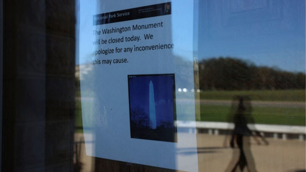 A person walks outside of the Washington Monument as a sign announces it is closed, on the fourth day of a partial government shutdown in Washington, D.C., U.S., October 4, 2025. (Reuters/Anna Rose Layden)