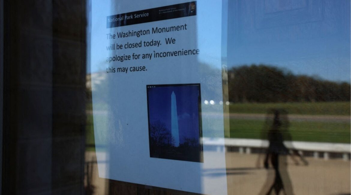 A person walks outside of the Washington Monument as a sign announces it is closed, on the fourth day of a partial government shutdown in Washington, D.C., U.S., October 4, 2025. (Reuters/Anna Rose Layden)