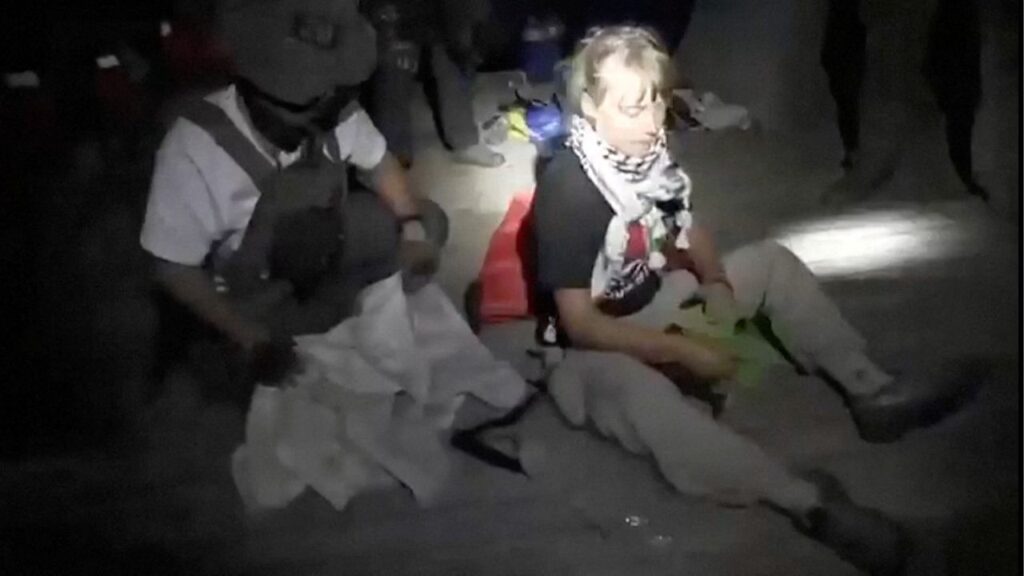 A screengrab from a video shows Swedish activist Greta Thunberg sitting next to a person wearing tactical gear, as vessels of the Global Sumud Flotilla are being intercepted by Israeli security forces, October 1, 2025. Israel Foreign Ministry/Handout via REUTERS
