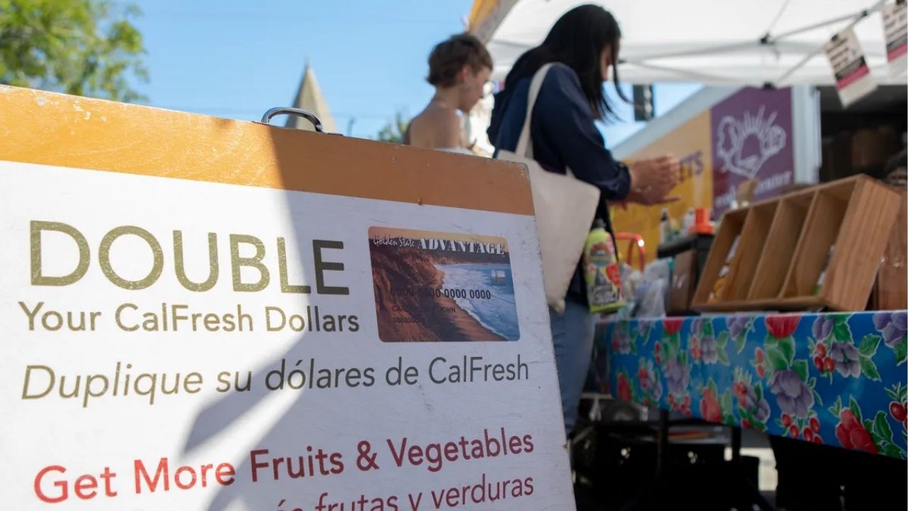A sign advertising “Market Match,” a program that matches CalFresh benefits up to $10 for purchasing fruits and vegetables, at the Ecology Center farmers market in North Berkeley on July 11, 2019. (Anne Wernikoff/CalMatters)