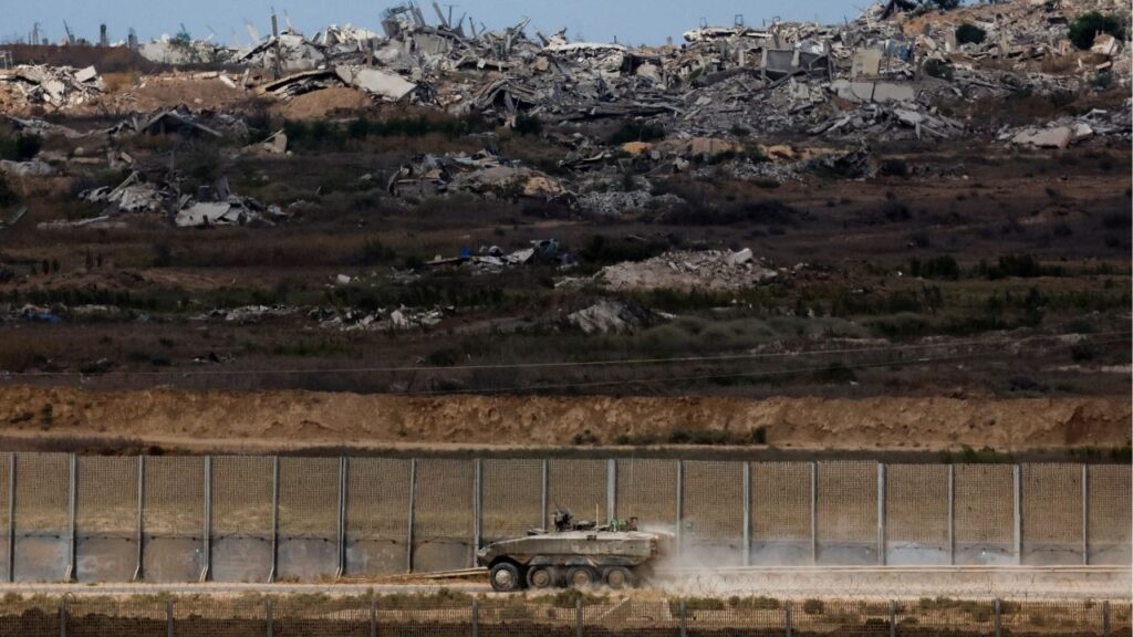 An Israeli armoured personnel carrier (APC) manoeuvres, after U.S. President Donald Trump announced that Israel and Hamas agreed on the first phase of a Gaza ceasefire, on the Israeli side of the border with Gaza, October 9, 2025. (Reuters/Ammar Awad)