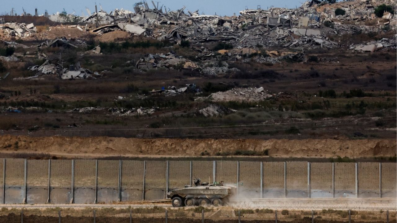 An Israeli armoured personnel carrier (APC) manoeuvres, after U.S. President Donald Trump announced that Israel and Hamas agreed on the first phase of a Gaza ceasefire, on the Israeli side of the border with Gaza, October 9, 2025. (Reuters/Ammar Awad)