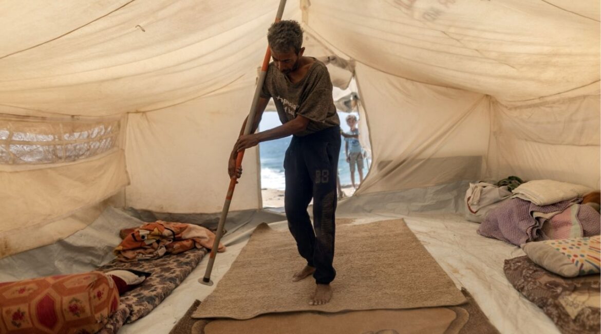 Bassem al-Qedra, 43, the father of six children, pitches a tent after securing a spot at the al-Mawasi camp near Khan Younis, Gaza Strip, on Wednesday, Sept. 17, 2025. Amid the Israeli military’s ground assault on Gaza City, the huge influx of Gazans fleeing to the south has further strained humanitarian services that aid groups say were not sufficient even before the arrival of many thousands more. (Saher Alghorra/The New York Times)