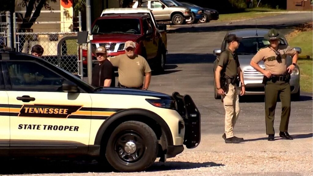 Law enforcement officers guard a gate outside the Accurate Energetic Systems military explosives plant, after an explosion at the facility in Bucksnort, Tennessee, U.S. October 10, 2025 in a still image from video. ABC Affiliate WKRN via REUTERS