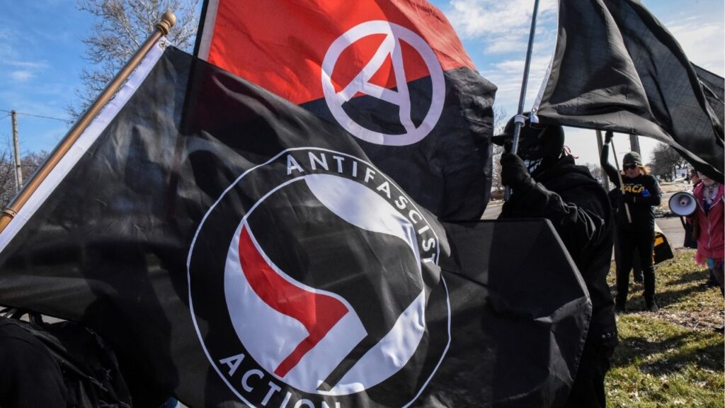 Members of the Great Lakes anti-fascist organization (Antifa) fly flags during a protest against the Alt-right outside a hotel in Warren, Michigan, U.S., March 4, 2018. (Reuters File)
