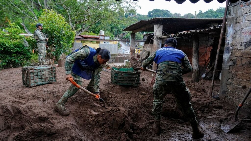 Members of the Mexican navy remove mud from the courtyard of a house as torrential rains from tropical storm Raymond triggered landslides and flooding in Jalcocotan, Nayarit state, Mexico October 12, 2025. (Reuters/Christian Ruano)