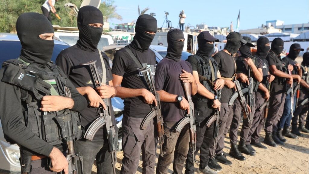 Palestinian militants stand guard on the day that hostages held in Gaza since the deadly October 7, 2023 attack, are handed over to the International Committee of the Red Cross (ICRC), as part of a ceasefire and hostages-prisoners swap deal between Hamas and Israel, in Khan Younis, southern Gaza Strip, October 13, 2025. (Reuters/Ramadan Abed)