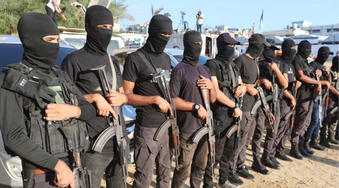 Palestinian militants stand guard on the day that hostages held in Gaza since the deadly October 7, 2023 attack, are handed over to the International Committee of the Red Cross (ICRC), as part of a ceasefire and hostages-prisoners swap deal between Hamas and Israel, in Khan Younis, southern Gaza Strip, October 13, 2025. (Reuters/Ramadan Abed)