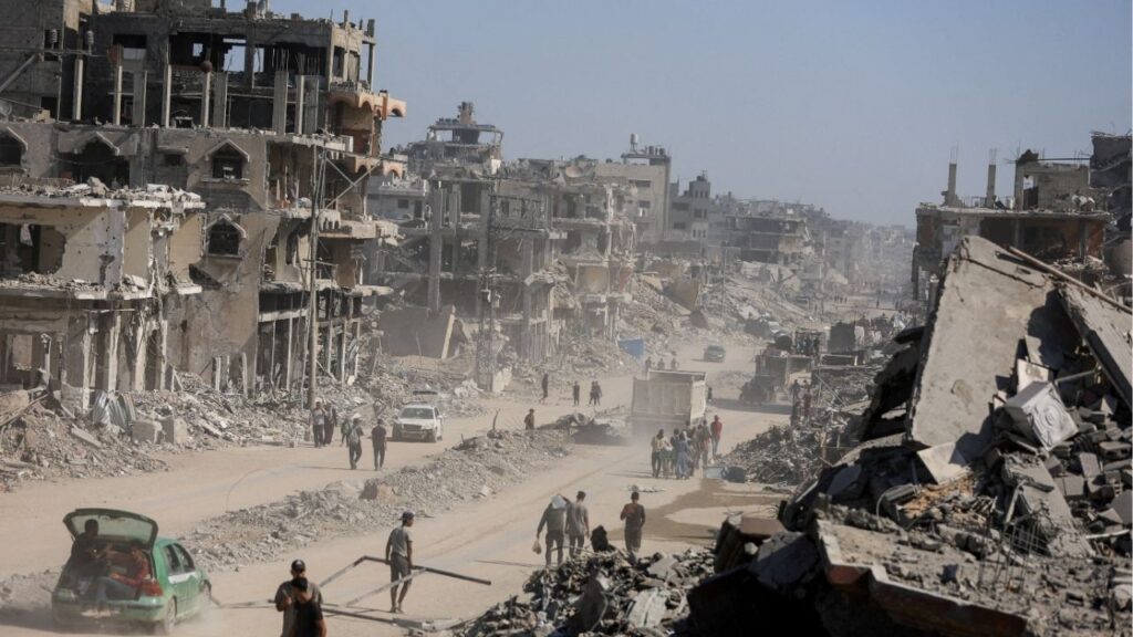 Palestinians walk past the rubble of destroyed buildings, amid a ceasefire between Israel and Hamas, in Gaza City, October 16, 2025. (Reuters File)