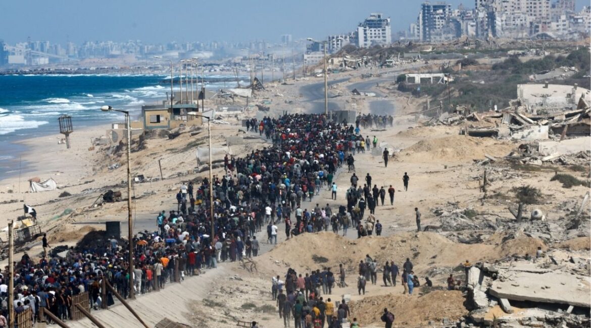 Palestinians, who were displaced to the southern part of Gaza at Israel's order during the war, walk along a road as they attempt to return to the north after a ceasefire between Israel and Hamas in Gaza went into effect, in the central Gaza Strip, October 10, 2025. REUTERS/Mahmoud Issa