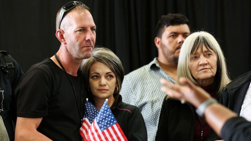 People from the first group of white South Africans granted refugee status, listen to welcoming remarks during a meet and greet event, at Dulles International Airport, in Dulles, Virginia, U.S., May 12, 2025. (Reuters/Kevin Lamarque)
