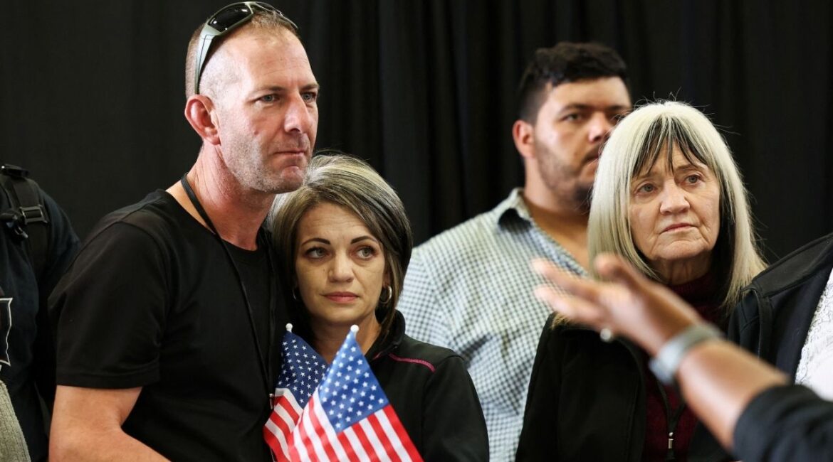 People from the first group of white South Africans granted refugee status, listen to welcoming remarks during a meet and greet event, at Dulles International Airport, in Dulles, Virginia, U.S., May 12, 2025. (Reuters/Kevin Lamarque)