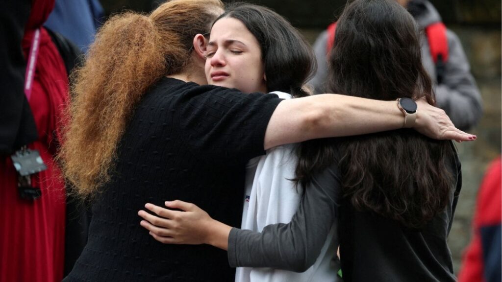 People react near the scene, after an attack in which a car was driven at pedestrians and stabbings were reported near a synagogue in north Manchester, Britain, October 2, 2025. (Reuters/Phil Noble)