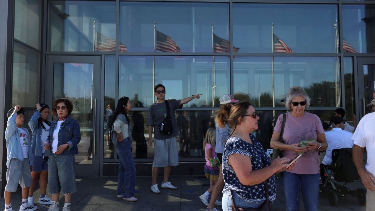 People stand outside of the Washington Monument, which is closed for tours, on the fourth day of a partial government shutdown in Washington, D.C., U.S., October 4, 2025. (Reuters/Anna Rose Layden)