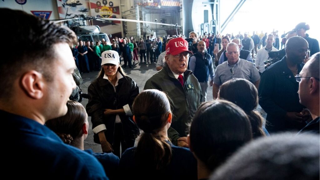 President Donald Trump and first lady Melania Trump greet troops aboard the USS George H.W. Bush off the coast of Norfolk, Va., on Sunday, Oct. 5, 2025. President Trump on Sunday called the deadly U.S. military strikes on boats in the Caribbean Sea “an act of kindness,” claiming that the attacks had halted drug trafficking via those waters into the United States. (Doug Mills/The New York Times)